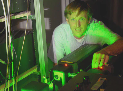 **Getting Pumped Up:** Dr. Dunn with the pump laser for the Ti:sapphire laser used in two-photon microscopy.